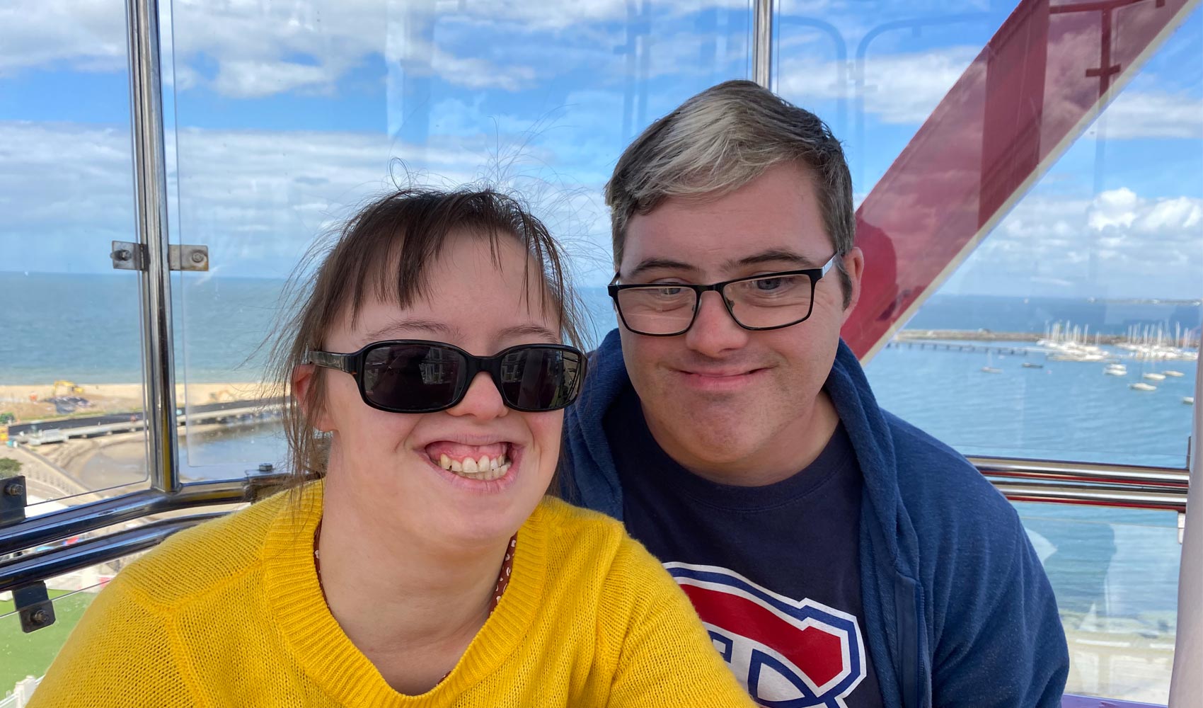close up of a young woman wearing sunglasses and a young man smiling respite